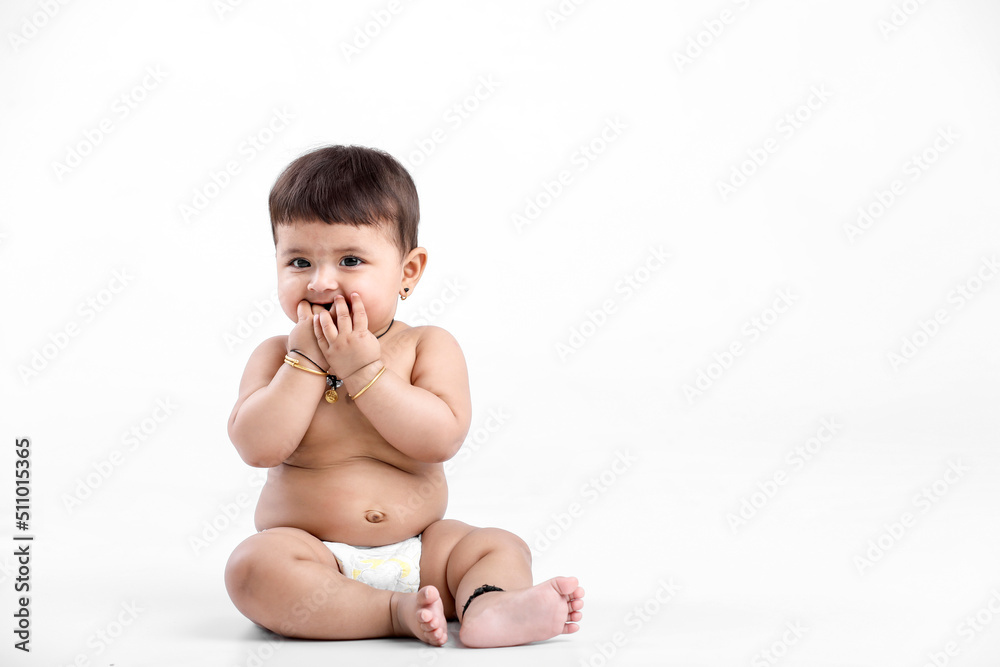 Indian baby girl playing on white background. Indian baby girl playing on white background.