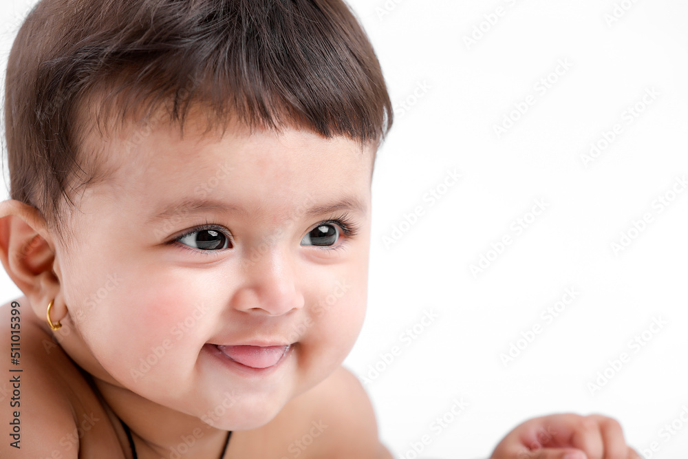 Indian baby girl playing on white background.