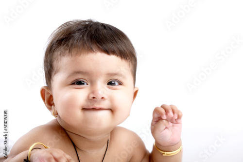 Canvas Print Indian baby girl playing on white background.