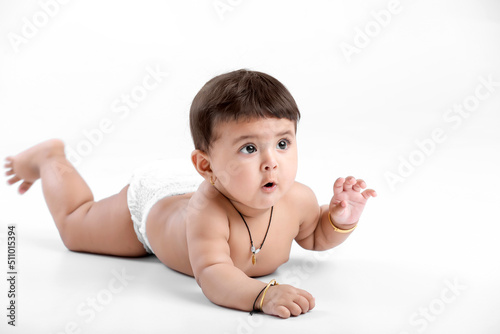 Canvas Print Indian baby girl playing on white background.