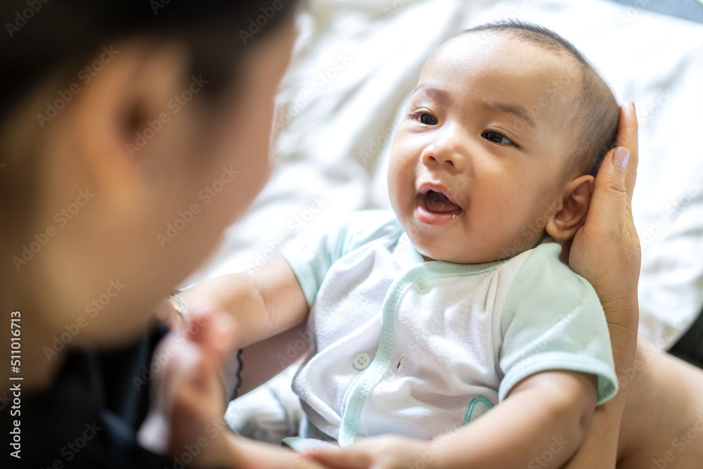 Portrait of enjoy happy love family asian mother playing with adorable little asian baby.Mom touching with cute son moments good time in a white bedroom.Love of family concept. Portrait of enjoy happy love family asian mother playing with adorable little asian baby.Mom touching with cute son moments good time in a white bedroom.Love of family concept.