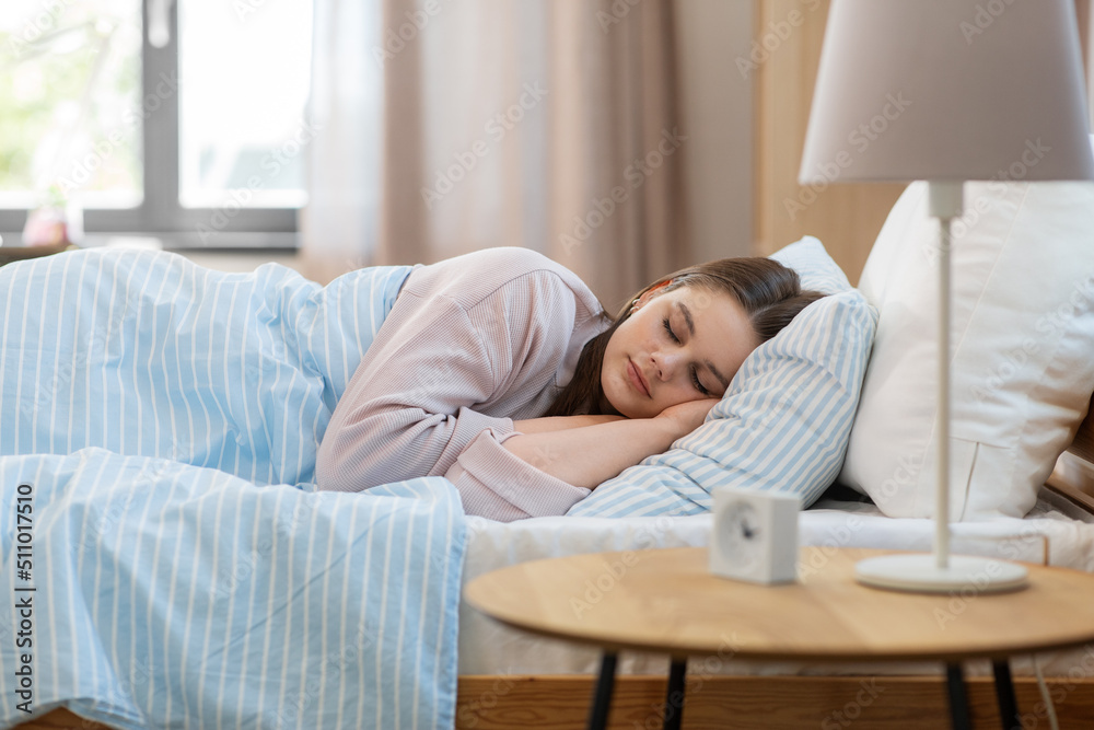 people, bedtime and rest concept - girl sleeping in bed at home in morning people, bedtime and rest concept - girl sleeping in bed at home in morning