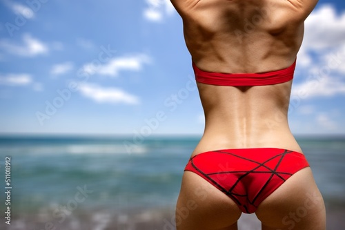 Ideal woman's butt and hips, perfect anti-cellulite and skin care therapy program. Ocean beach photo.