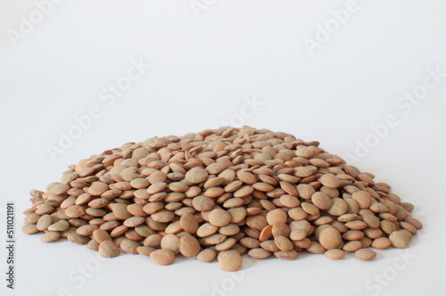 Lentils, close-up of a mound of dried lentils with isolated white background. Healthy staple, nutritional powerhouses packed with plant-based protein and fiber.