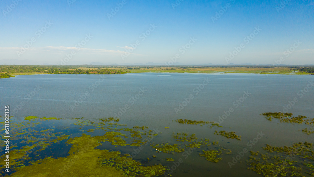 Tropical landscape: Lake and mountains in the distance on Sri Lanka. Arugam Lagoon.