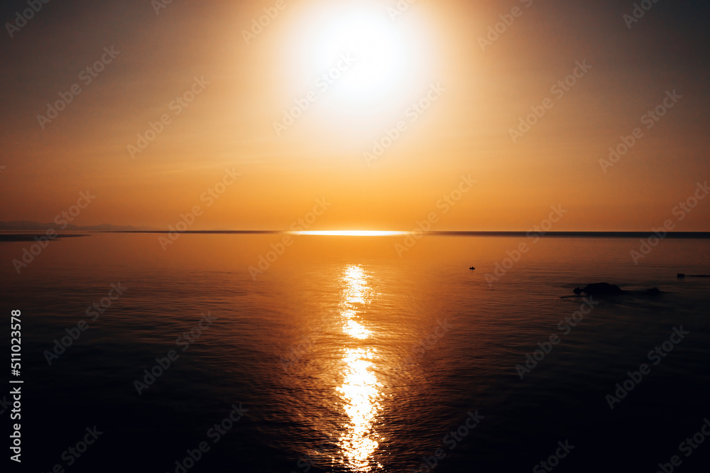 Naklejka premium sunset at sea. variety of colors and hues of the rising sun. . High quality photo