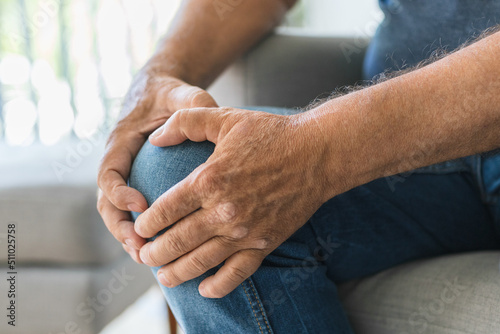 Photography Senior holding his painful knee
