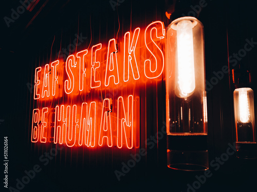 Closeup of red neon lighting lettering 