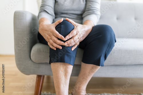 Senior woman holding her painful knee