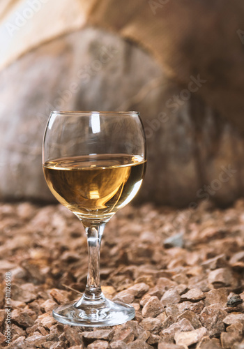a glass of white wine in a wine cellar
