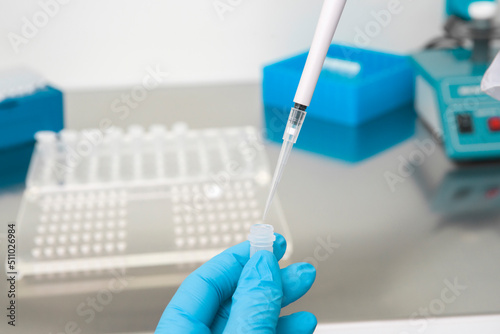Doctor holding blood tube test in the research laboratory.Corona virus pandemic concept.Coronavirus vaccine development