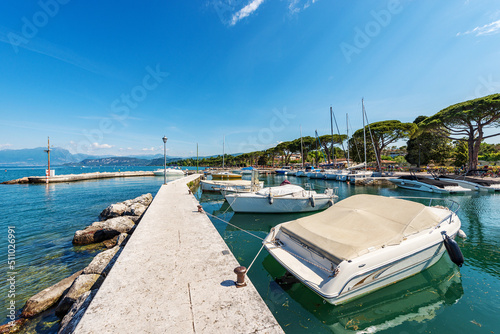 Small port on the coast of Lake Garda (Lago di Garda). Village of Lazise, tourist resort in Verona province, Veneto, Italy, southern Europe. On the horizon the Lombardy coastline. © Alberto Masnovo