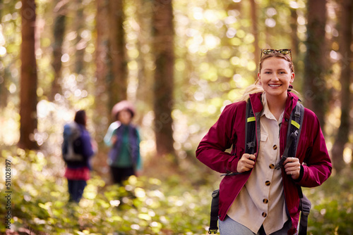 Portrait Of Woman With Group Of Female Friends On Camping Holiday Hiking In Woods Together