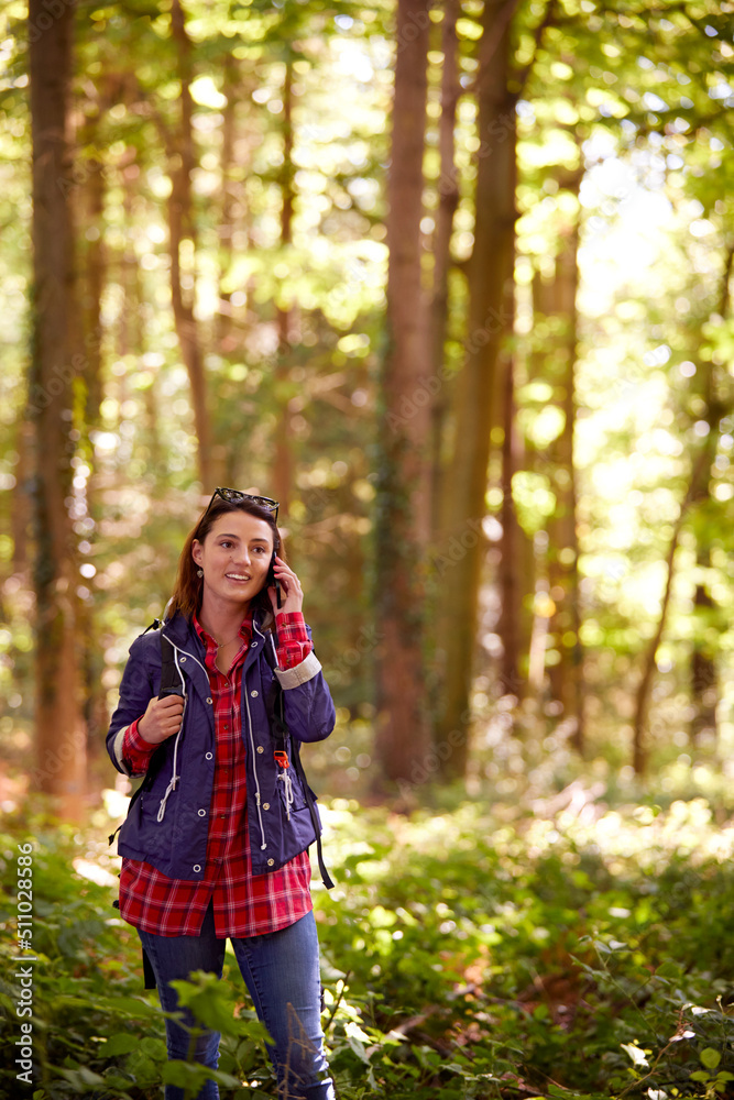 Woman On Hike Through Forest Talking On Mobile Phone Woman On Hike Through Forest Talking On Mobile Phone