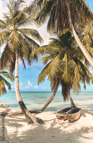 Palm trees on the beach of Saona island in the Caribbean sea. Summer landscape.