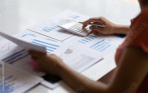 Accountant working on desk office with using a calculator to calculate the numbers and audit. Finance accounting concept.