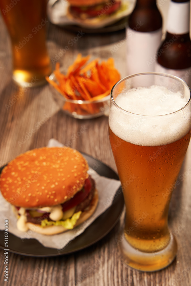 Bottles and glasses of beer with hamburgers Bottles and glasses of beer with hamburgers