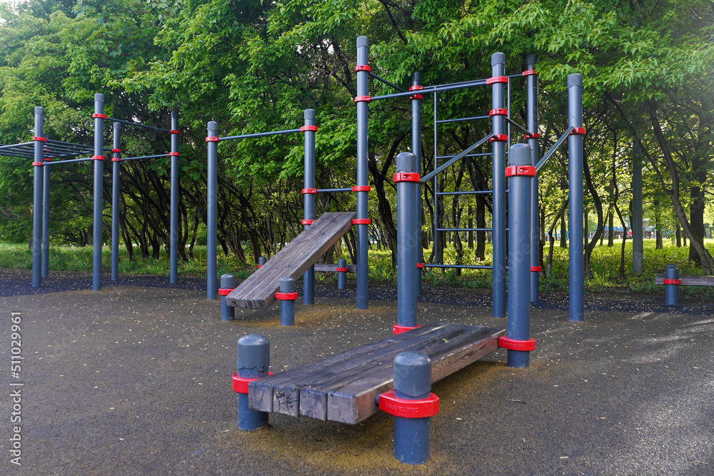 Playground for workout in a public park with trees in background Playground for workout in a public park with trees in background