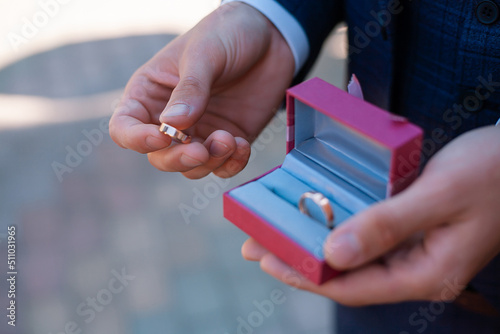 wedding rings in a box in the hands of the groom
