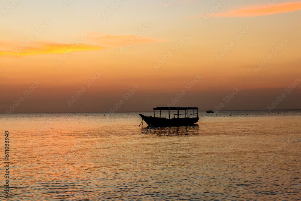 Wooden boat in the Indian ocean at sunset on Zanzibar, Tanzania
