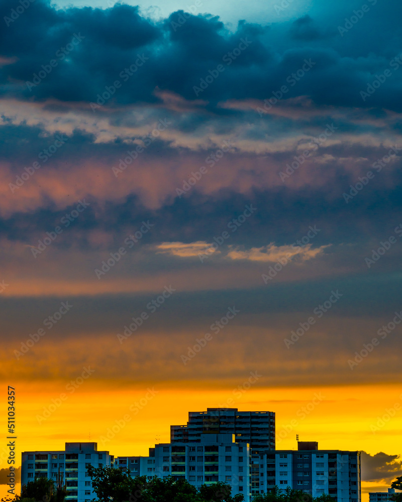 Dramatic sky at sunset over city buildings