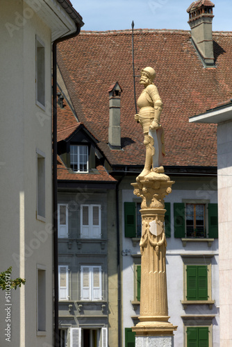 Stone fountain with soldier statue at the old town of Payerne, switzerland