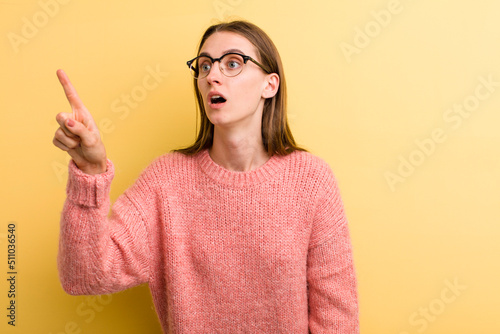 Photography young adult pretty woman feeling shocked and surprised, pointing and looking upw