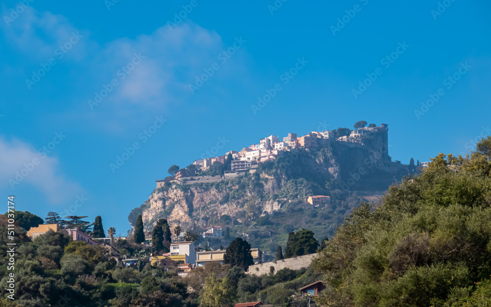 Panoramic view from the small tourist village Taormina on the mountain village Castelmola, Sicily, Province of Messina, Italy, Europe, EU. Hilltop town on Monte tauro. Mountainous landscape