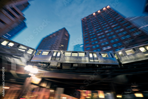 Elevated train in Chicago in blurred motion against skyscrapers in downtown disctrict at night.. photo