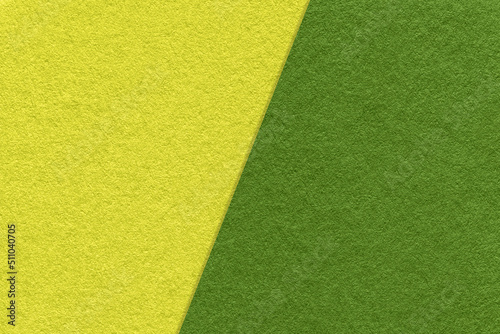 Texture of craft green and olive paper background, half two colors, macro. Structure of vintage craft yellow cardboard.