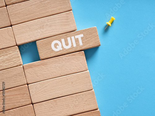 The word quit written on wooden blocks. To quit job or resignation photo