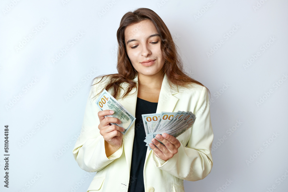 Beautiful girl counts money holding them in her hands. Business and profit concept. Beautiful girl counts money holding them in her hands. Business and profit concept.