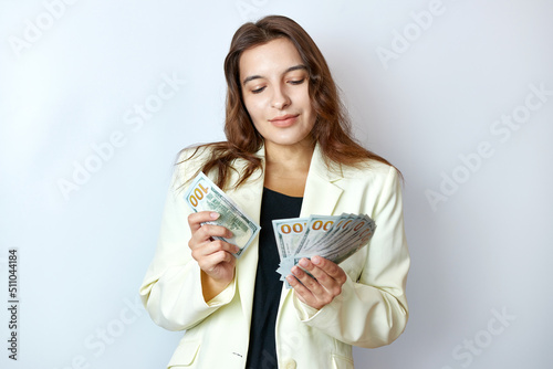 Beautiful girl counts money holding them in her hands. Business and profit concept.