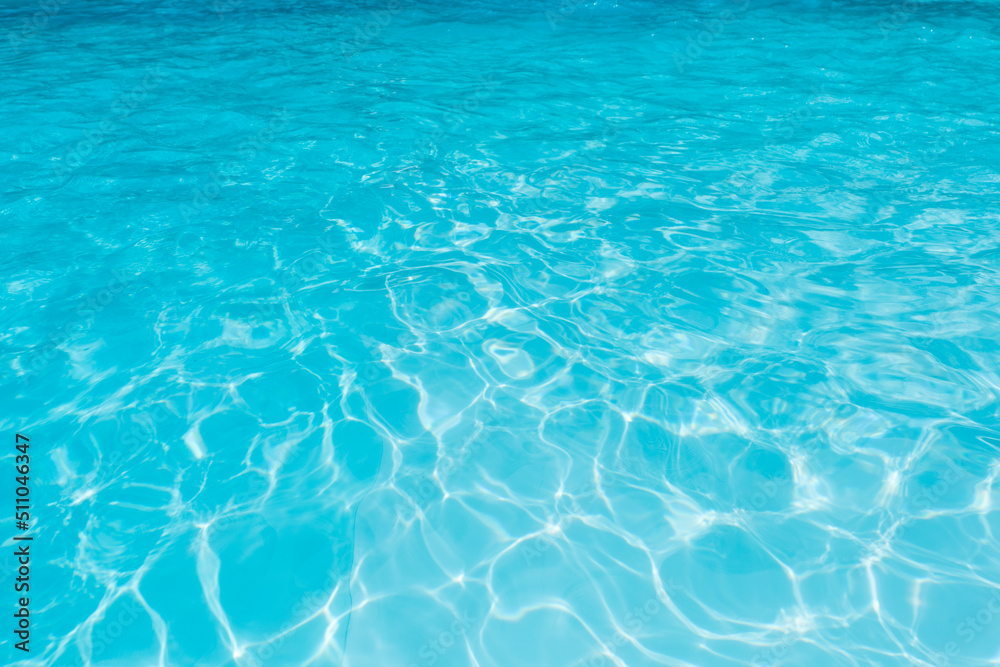 Blue water in swimming pool with sun reflection