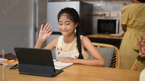 Happy asian child learning online at virtual class on laptop computer. Concept of Virtual education, homeschooling