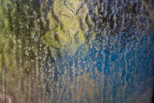Frosted glass of privacy glass abstract texture wallpaper. Blue and green tone refracting from behind. Close up shot  no people