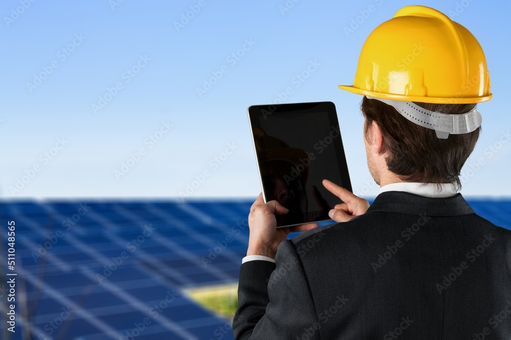A handyman talking a picture of installed solar panels on roof cocnept. A handyman talking a picture of installed solar panels on roof cocnept.