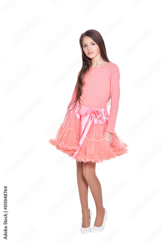Beautiful girl in pink dress posing on white background