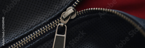 Closeup of zipper on blue leather jacket photo