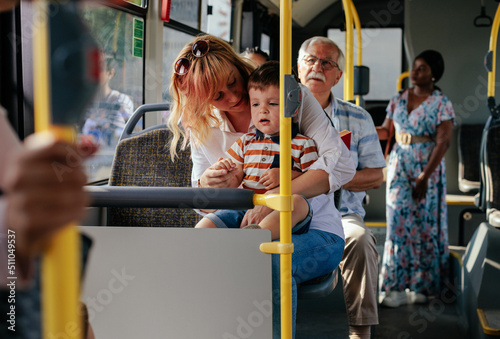 Fotografering Mom and son in city bus