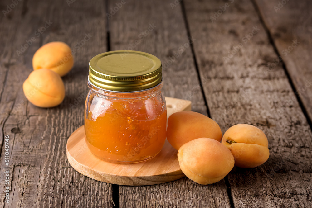 Jar of Apricot Jam on Wooden Cutting Board Homemade Raw Apricot Horizontal Jar of Apricot Jam on Wooden Cutting Board Homemade Raw Apricot Horizontal
