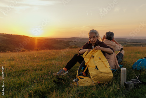 Couple packing for hiking at sunrise