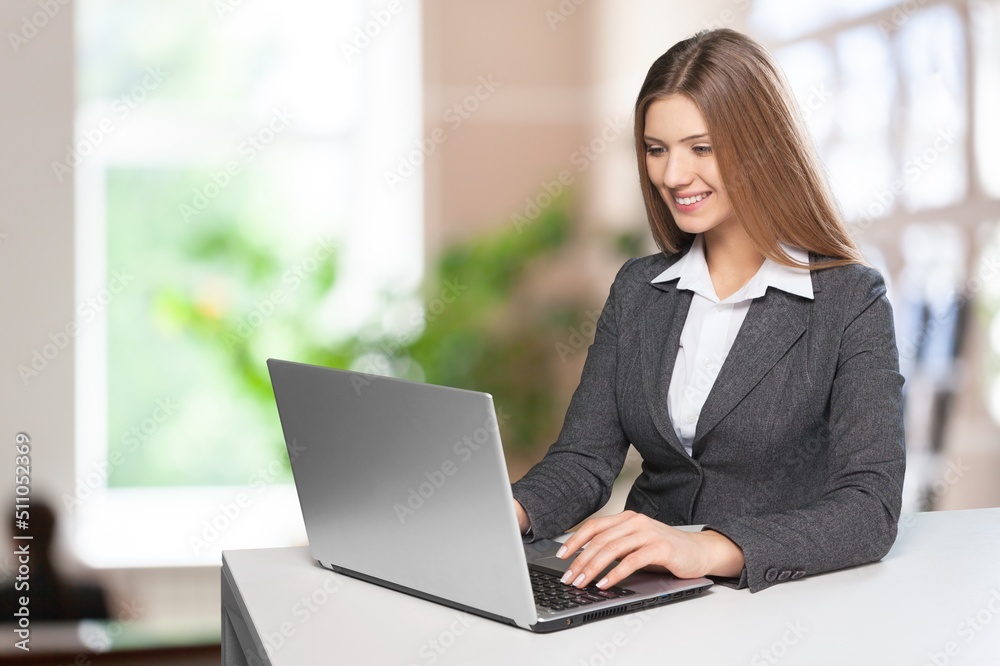 Portrait of smiling beautiful business woman working in office use computer. Business owner people Portrait of smiling beautiful business woman working in office use computer. Business owner people