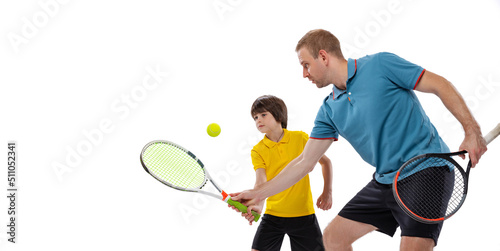 Training. Professional tennis player, coach teaches teen to play tennis isolated over white studio background. Concept of sport, achievements, hobby, skills