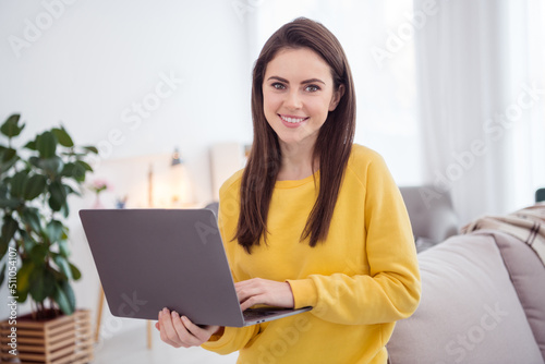 Portrait of charming cheerful lady toothy smile hold wireless netbook house indoors © deagreez