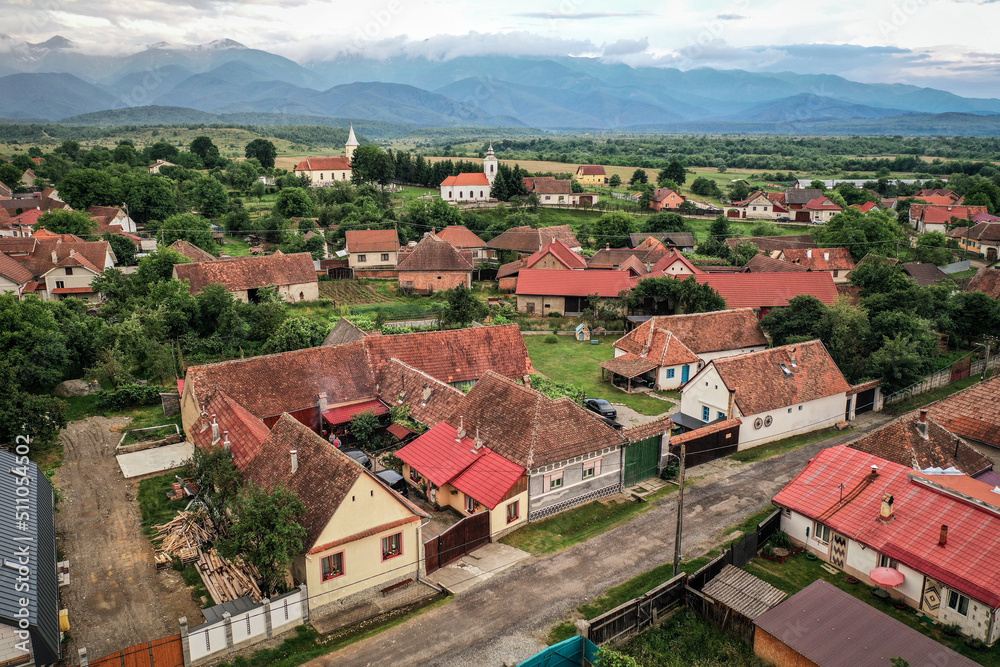 Transylvanian old village of Porumbacu photographed from drone with Fagaras mountains in the background