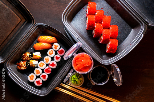 Set of delicious sushi rolls with wassabi and ginger in a box. Japanese food. photo