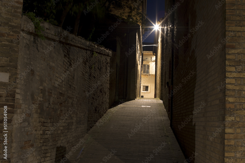 Narrow brick walkway in the city. Old Town at night. A romantic summer night at the castle