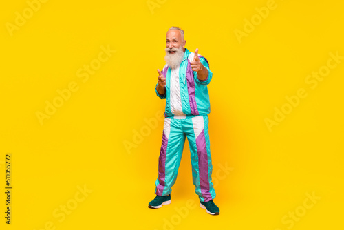 Full length photo of positive excited person point fingers camera you isolated on yellow color background