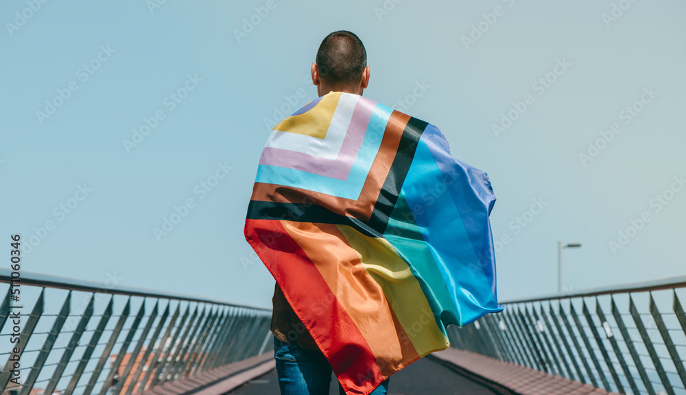 wrapped in intersex-inclusive progress pride flag - obrazy, fototapety, plakaty 